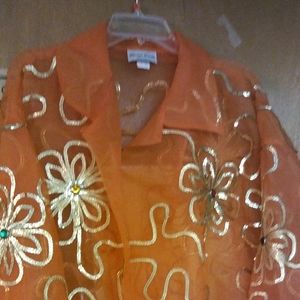 Gold accent orange blouse.